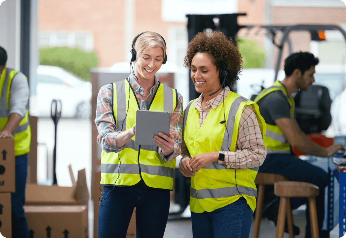a team of people preparing to load cargo into trucks as part of drayage logistics