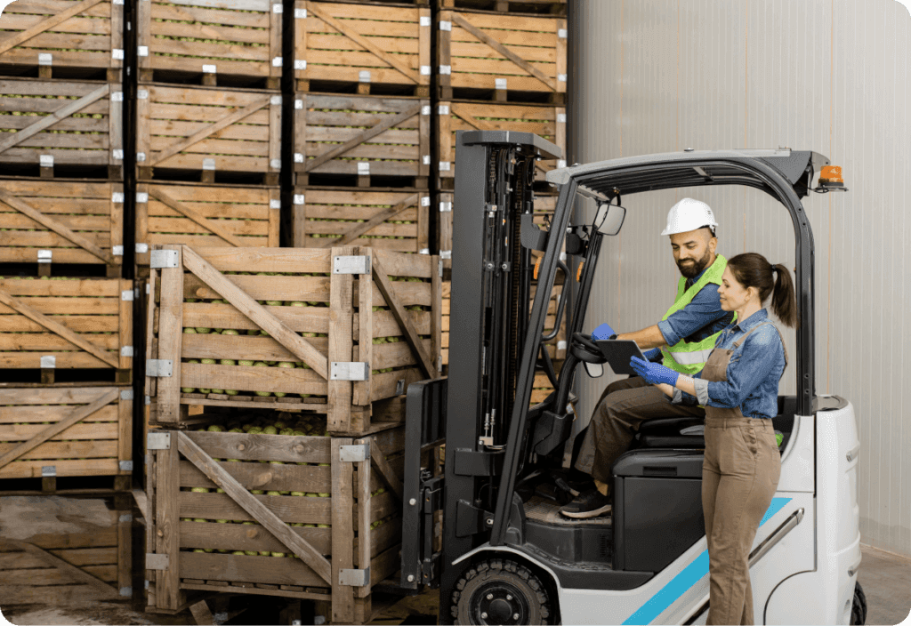 Two warehouse employees using a forklift for optimized inventory processes and warehouse solutions