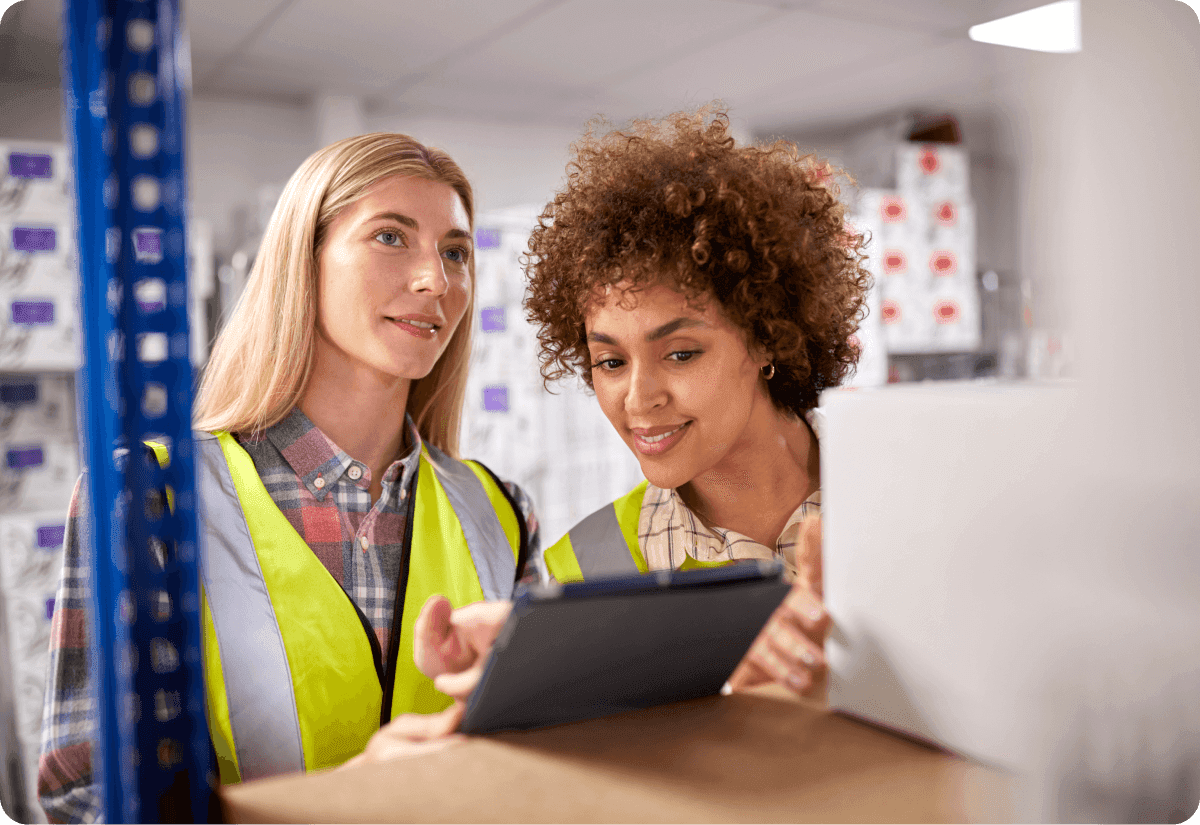 Two female employees using the latest technology for maximum route optimization of cargo