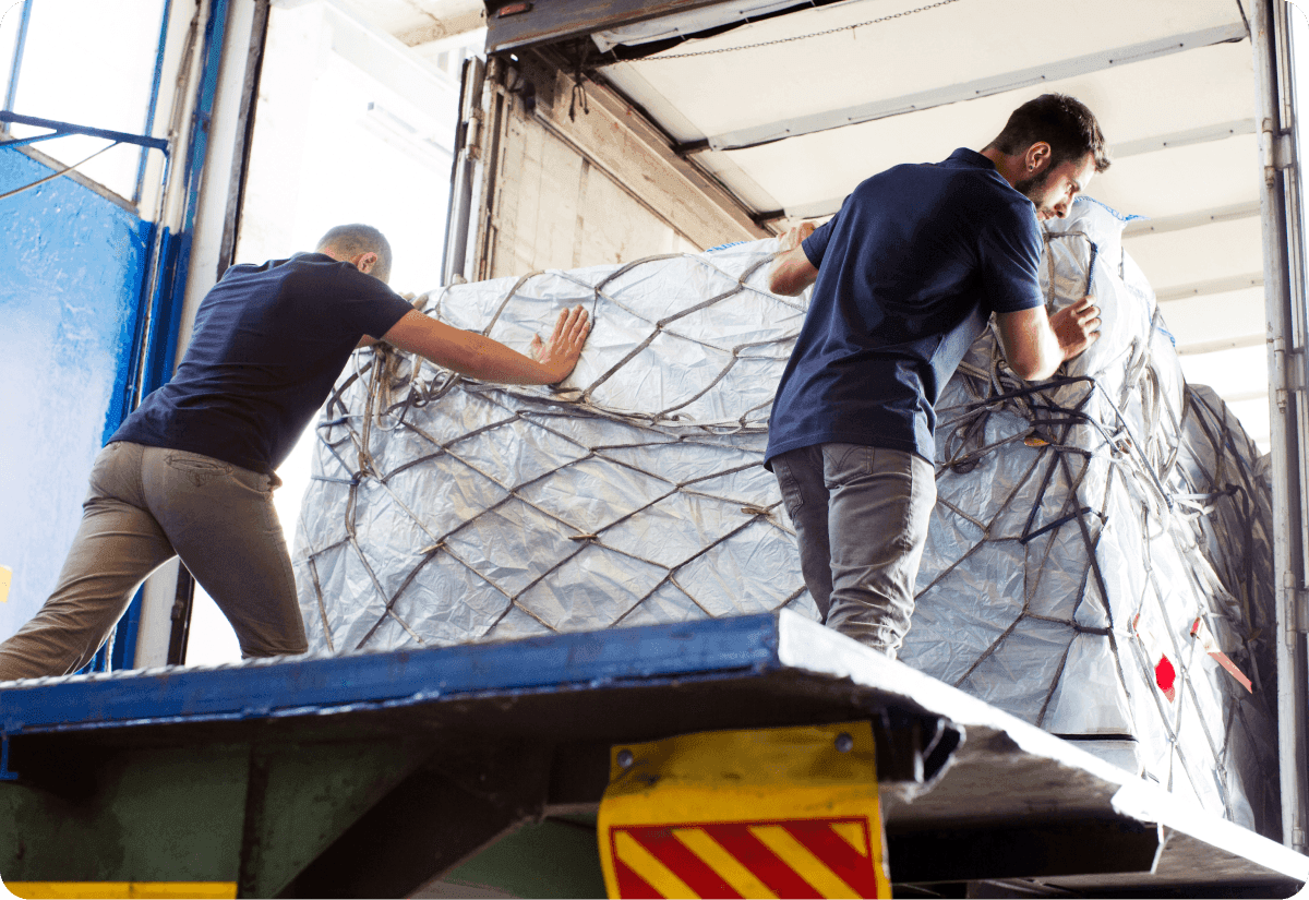 a worker loading cargo into a truck to meet on demand freight expectations
