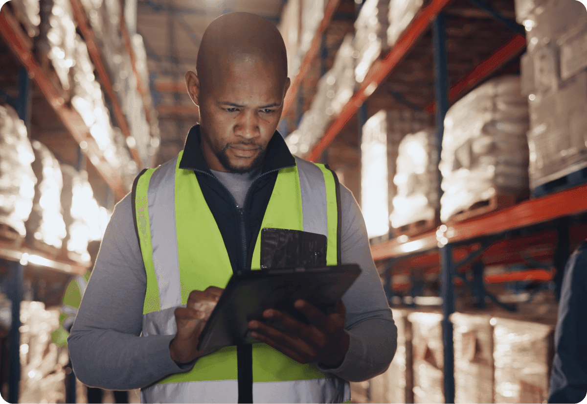 a warehouse employee checks for inventory availability using a digital device