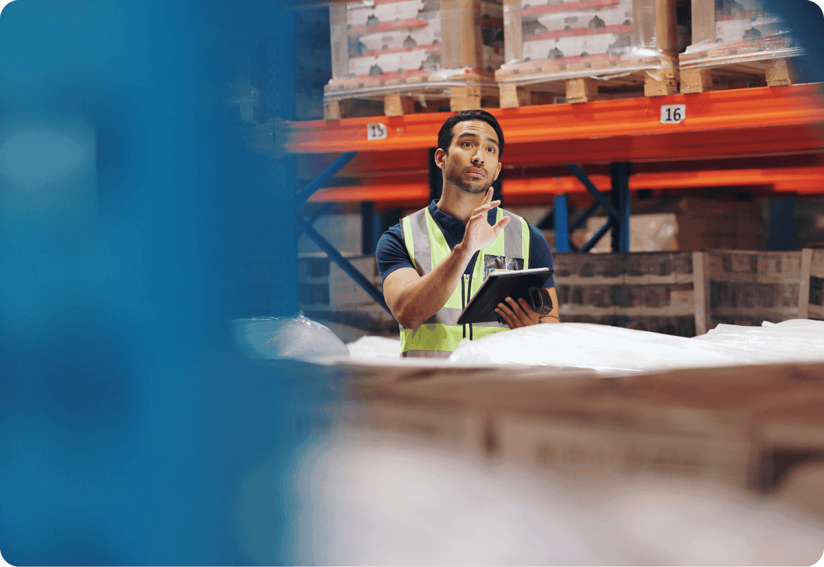 warehouse worker utilizes predictive analytics solutions to help improve supply chain processes