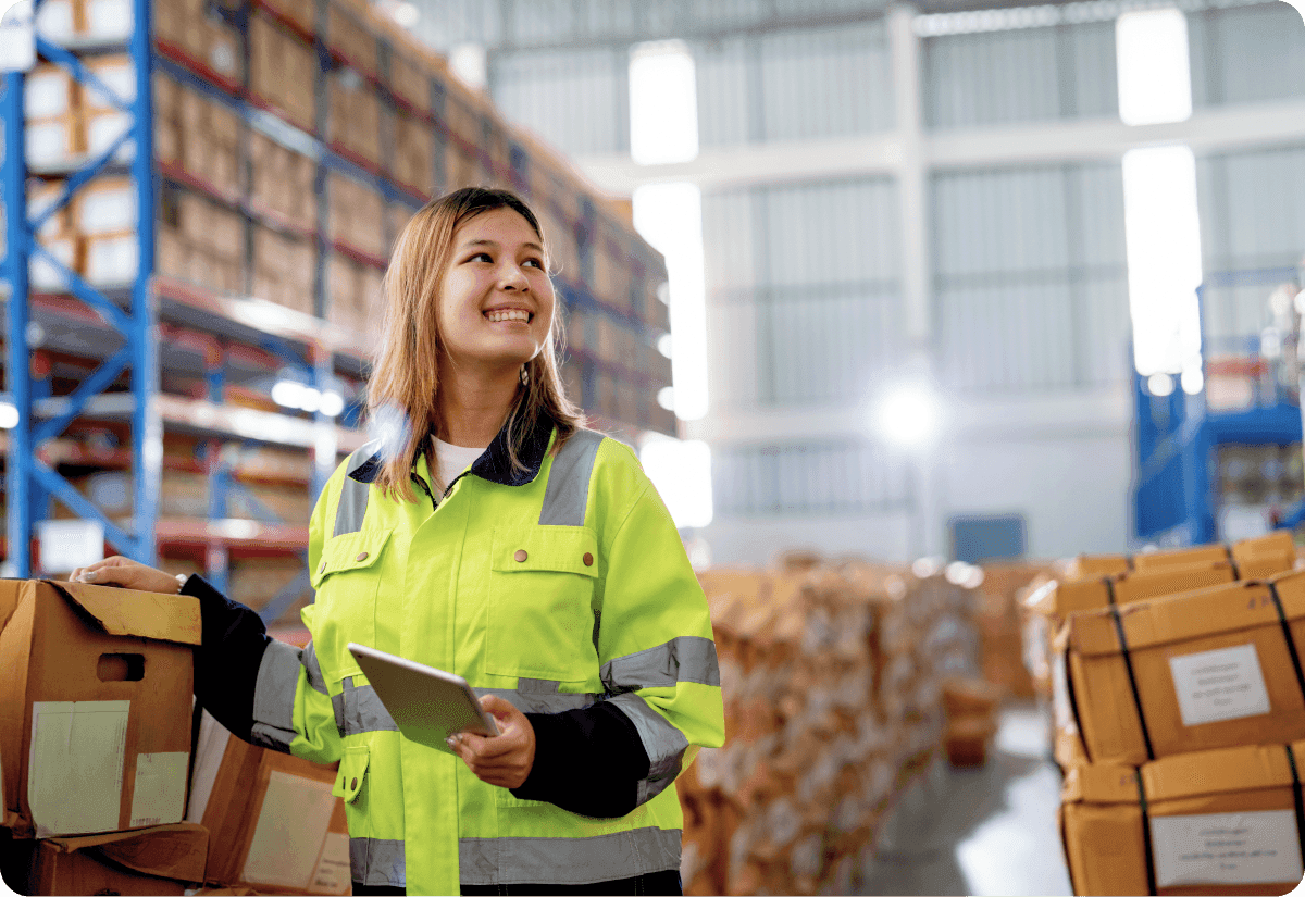 a warehouse worker uses an app for effective shipment tracking
