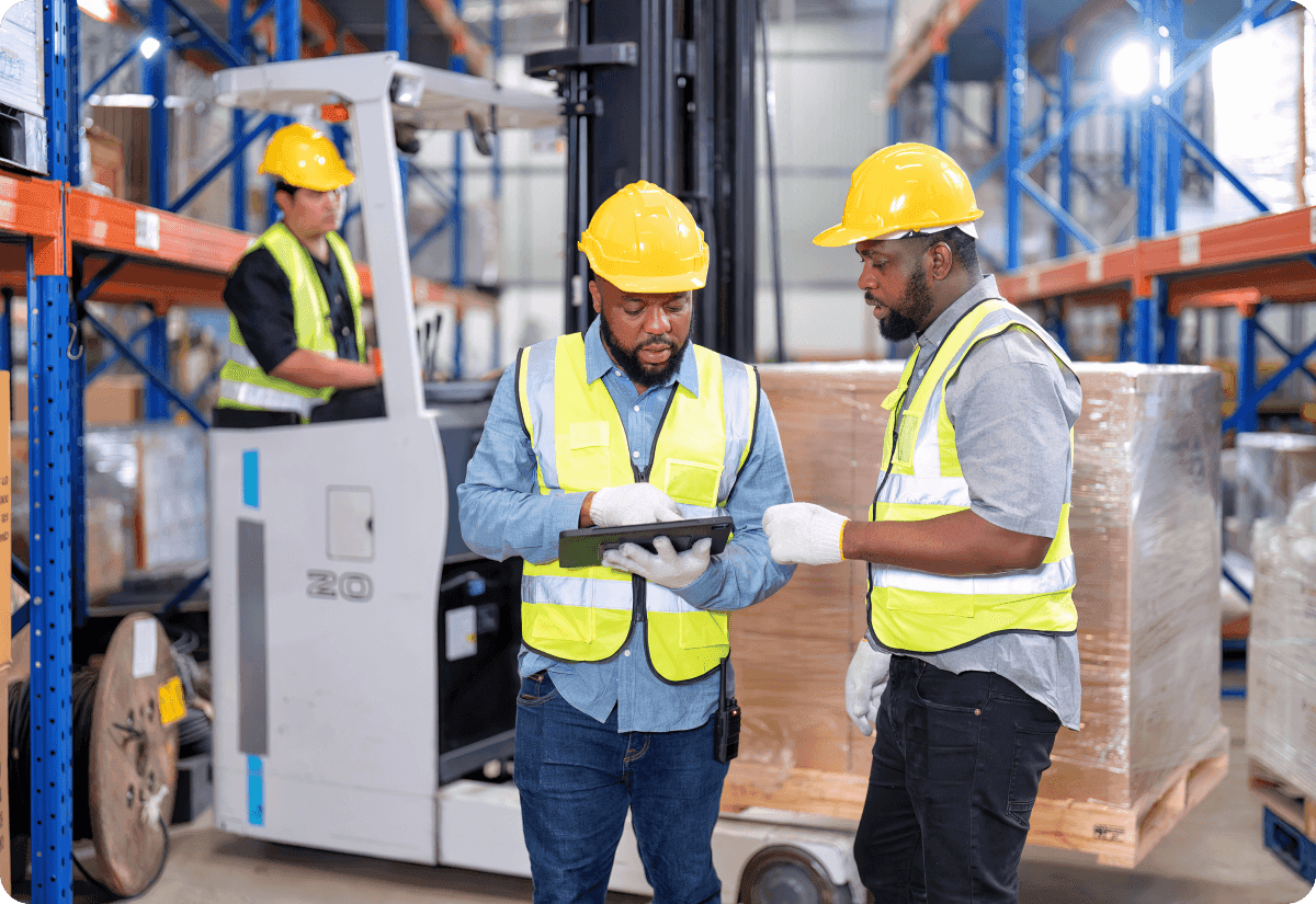 a team of warehouse employees discussing freight pricing