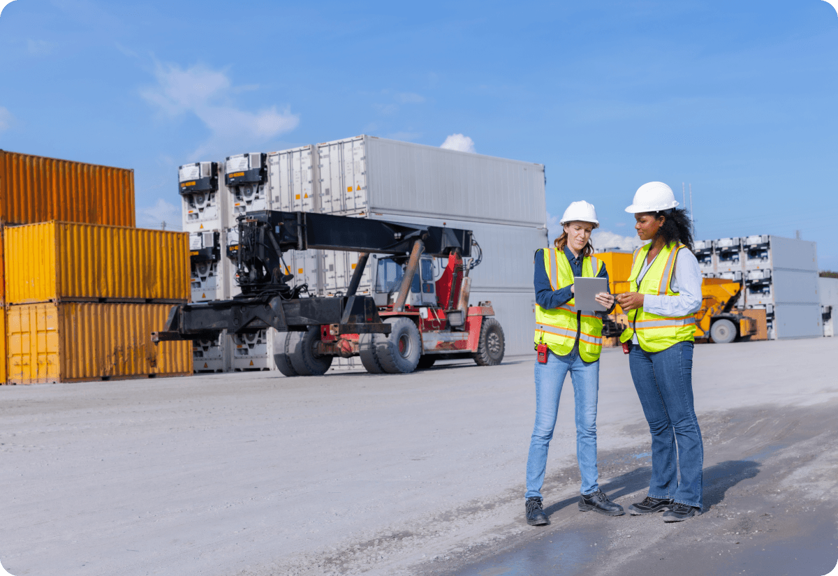 Logistics employees communicating supply chain delays immediately via device