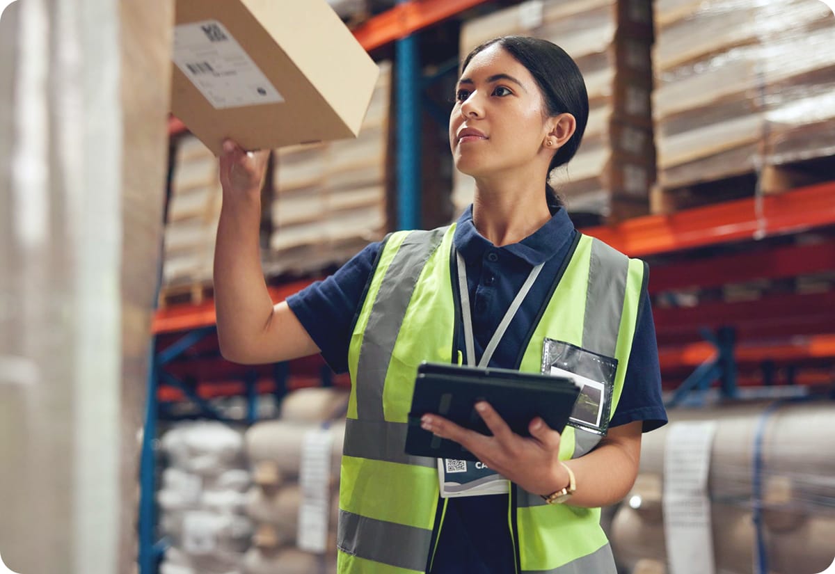 an employee checking parcels in a warehouse that uses warehouse mezzanine systems