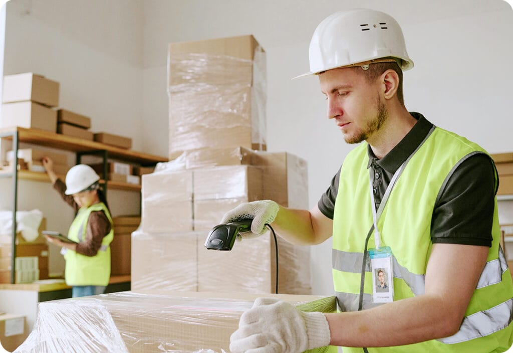 Warehouse employees making the most of packaging efficiency solutions while checking parcels