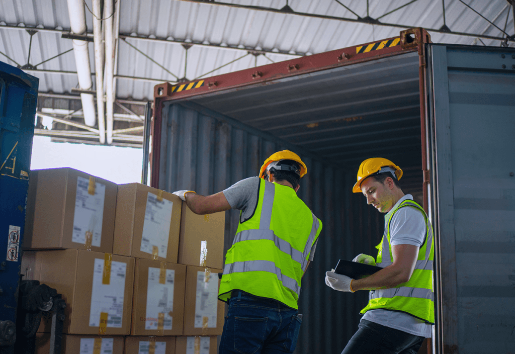 Employees verifying inventory during the warehouse receiving process.