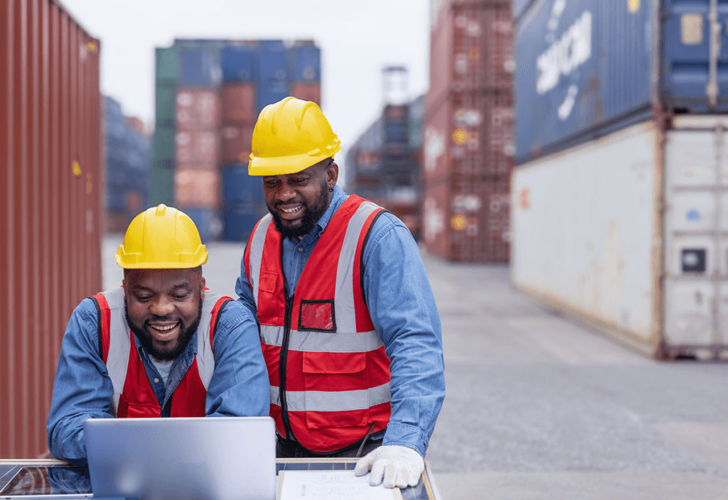 Employees reviewing logistics data on a laptop for effective supply chain planning.